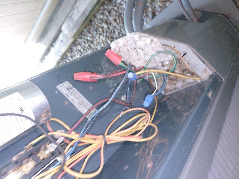 Responded to service call for 13-year-old air conditioning unit running but not producing cold air. Upon inspection, accessed electrical control panel and evaluated capacitor, contactor, and associated wiring connections. All components showed typical age-related wear but appeared functional with proper wire terminations and secure connections to terminal blocks.