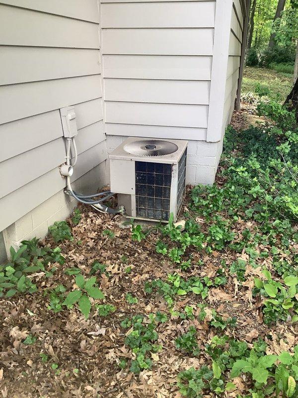 Responded to service call for air conditioning system not cooling properly throughout the residence. Performed diagnostic inspection of outdoor condenser unit and indoor air handler components. Upon examination, observed outdoor unit accessible but surrounded by vegetation and debris accumulation, which may restrict airflow and reduce system efficiency. Evaluated system performance and discussed findings with customer regarding current operational concerns. Recommended follow-up consultation to assess whether repair or full system replacement would be most cost-effective solution given the unit's condition and performance issues.