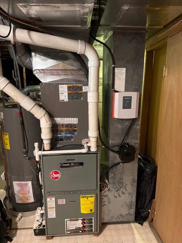 Completed first-time air conditioning and evaporator coil installation at residential property. Installed new A/C condenser unit with matching indoor evaporator coil, connected to existing Rheem Classic 90 Plus furnace system, verified electrical connections including fuse block installation, and ensured proper refrigerant line connections and system integration with existing ductwork and PVC ventilation piping.
