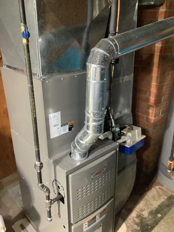 Completed full HVAC system replacement after existing outdoor condenser unit was damaged and crushed by ice. Installed new outdoor air conditioning condenser unit on concrete pad against exterior brick wall, positioned with proper clearance and connected to wall-mounted electrical disconnect box via conduit. Inside mechanical room, installed new evaporator coil system integrated with existing furnace, including all necessary refrigerant lines, ductwork transitions, and proper insulation. System tested and verified operational with proper airflow and refrigerant charge.