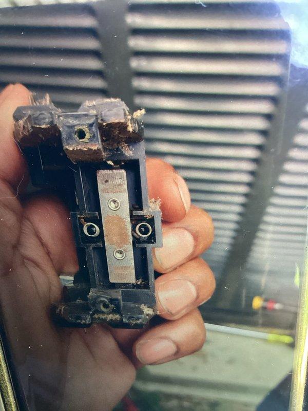 Responded to no cooling call on 10-year-old air conditioning system. Upon inspection, discovered failed contactor with severe electrical damage, including burned and melted housing, corroded contacts, and evidence of overheating. Performed insulation resistance test using megohmmeter which confirmed electrical failure reading in the "bad" range. Replaced damaged contactor and restored system to proper operation.