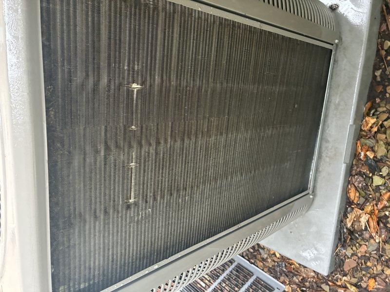 Completed comprehensive cooling system maintenance on a five-year-old air conditioning unit. Performed standard tune-up procedures including inspection of the outdoor condenser unit, evaluated heat exchanger and evaporator coil assembly condition, and assessed airflow through the finned panels. Unit showed normal wear with minor dirt accumulation on condenser screen and mesh surfaces; all components functioning within acceptable parameters for continued operation.