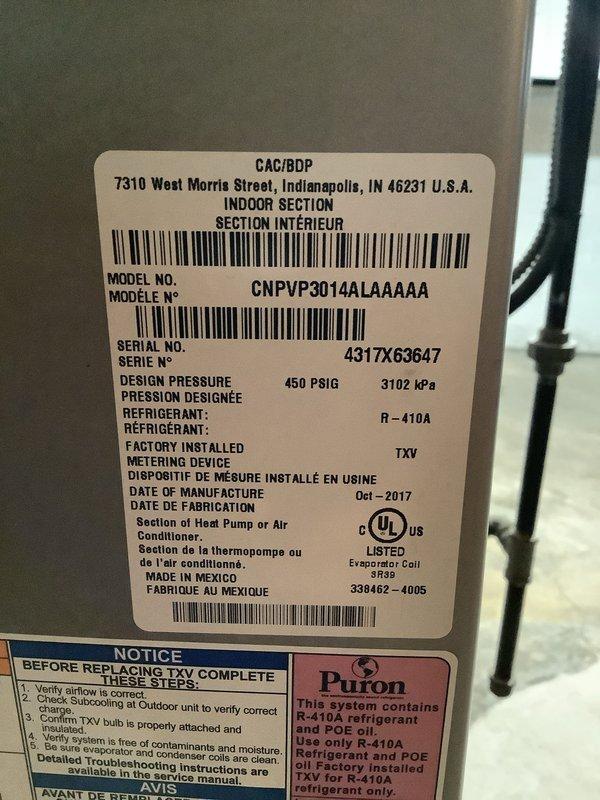 Responded to service call for insufficient cooling on central air conditioning system. Customer reported thermostat set to 68°F but indoor temperature reading 77°F, with system running continuously and cold air felt at furnace but inadequate cooling to main floor and upstairs. Inspected outdoor condenser unit, a 2017 Carrier CNPVP3014ALAAAAA model utilizing R-410A refrigerant, and verified unit operation. Documented equipment condition and specifications for service records.