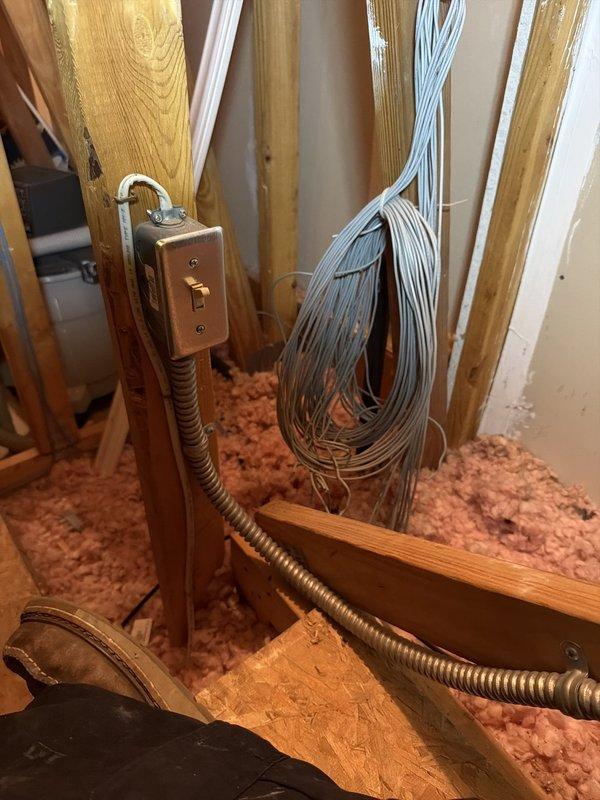 Completed installation of upflow air conditioning system with evaporator coil in large, open attic space. Installed new carbon monoxide alarm for safety compliance, ran electrical conduit and low-voltage wiring through exposed framing, and positioned equipment over insulated flooring in unfinished attic area.