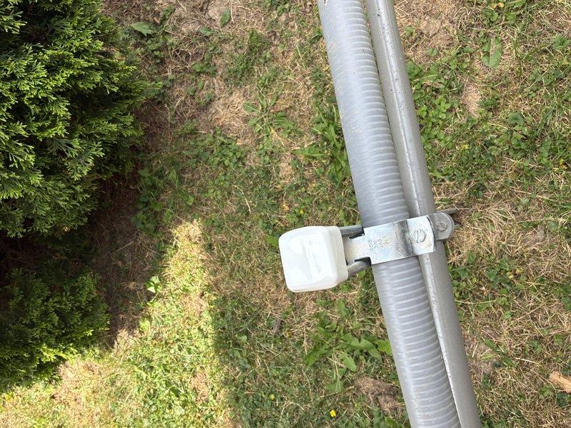 Completed warranty work following failed inspection by capping off exterior electrical post and securing flexible metallic conduit with proper mounting brackets and clamps. Installed white cushioned spacers on metal mounting hardware to ensure proper support and protection of conduit run across outdoor terrain. Delivered generator keys to customer upon completion of corrective work.