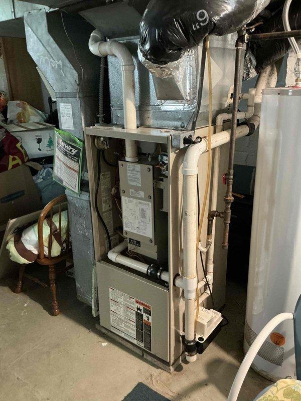 Conducted on-site evaluation of existing vertical furnace system in basement mechanical room to provide replacement estimate. Assessed current HVAC equipment configuration, ductwork connections, venting arrangement, and utility connections including gas lines, electrical service, and condensate drainage system to determine replacement specifications and installation requirements.