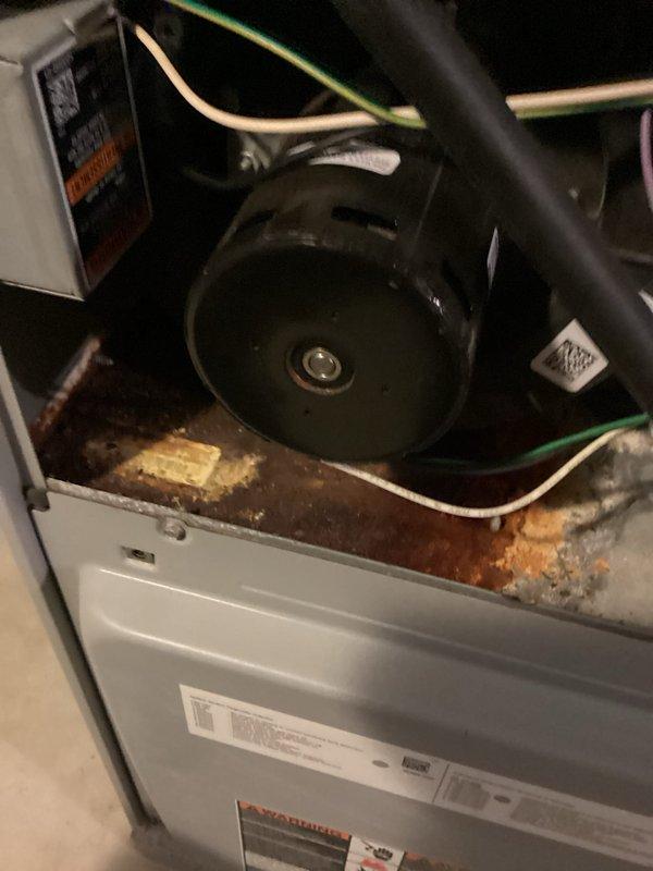Responded to service call for non-operational air conditioning system. Upon inspection, found significant rust and corrosion on the interior drip pan and base of the air handler, indicating prolonged moisture exposure. Examined outdoor condensing unit and identified a rusted capacitor requiring replacement. Replaced failed capacitor, tested system operation, and verified proper functionality of all electrical components and connections.