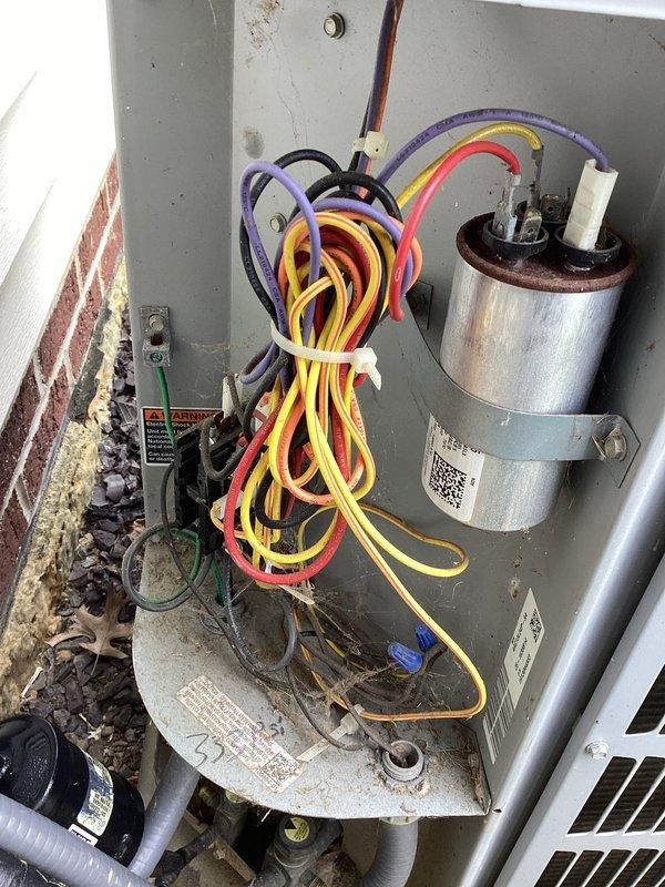 Responded to service call for non-operational air conditioning system. Upon inspection, found significant rust and corrosion on the interior drip pan and base of the air handler, indicating prolonged moisture exposure. Examined outdoor condensing unit and identified a rusted capacitor requiring replacement. Replaced failed capacitor, tested system operation, and verified proper functionality of all electrical components and connections.