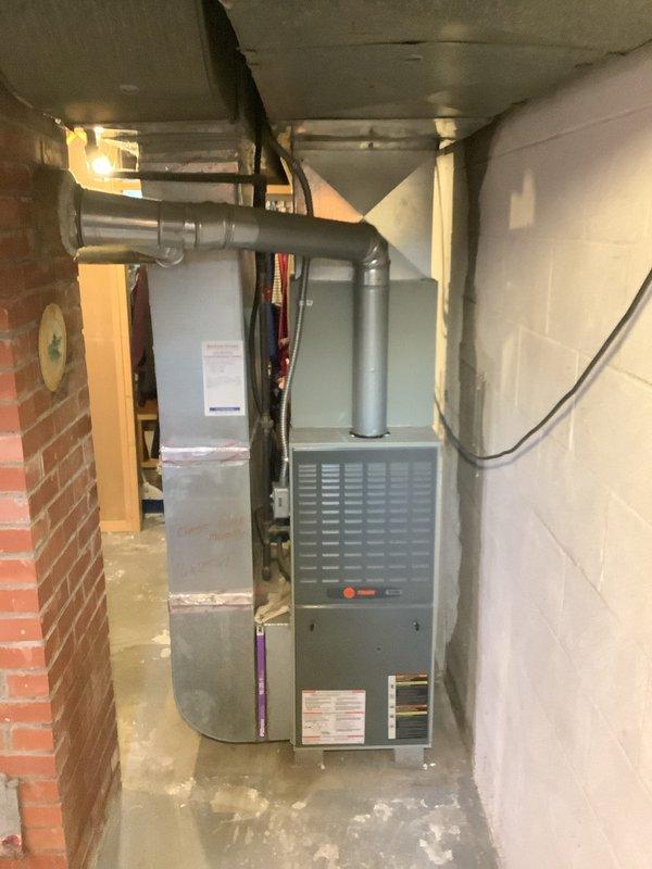 # HVAC Install - Complete System

Successfully completed installation of an 80% efficiency gas furnace system in basement utility area. Installed new furnace unit with proper ventilation ductwork, including horizontal and vertical duct runs secured to ceiling joists. Connected all electrical wiring and controls, ensuring proper power supply to unit with visible indicator lights functioning correctly. Coordinated installation alongside existing water heater to optimize space utilization in mechanical room. All copper refrigerant lines, PVC condensate drainage, and flexible ductwork properly routed and secured to manufacturer specifications. System tested and verified operational upon completion.