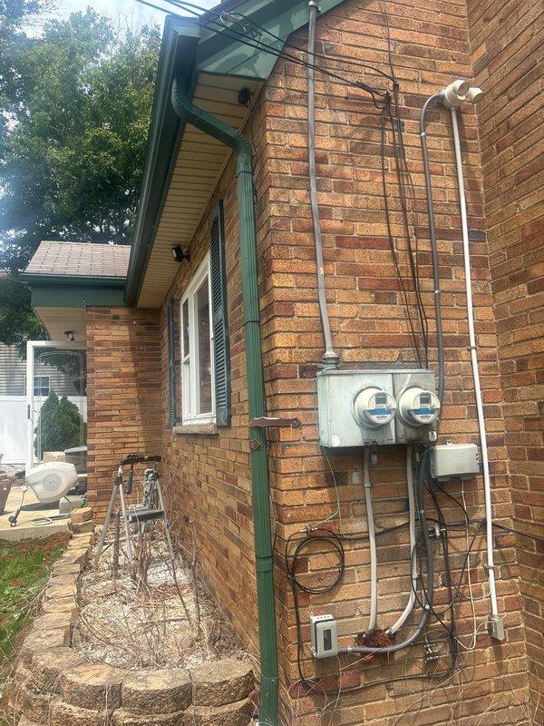 Installed four outdoor security cameras and two outdoor area lights on the exterior of a brick residential structure. Three cameras utilized existing wiring infrastructure, while one camera required rewiring to ensure proper placement and functionality. All electrical connections were made to code, conduit runs were secured to the brick facade, and fixtures were tested for proper operation upon completion.