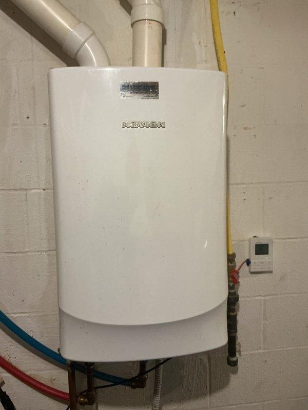 Responded to service call for tankless water heater providing hot water for only 1-2 minutes before running cold. Upon arrival, inspected wall-mounted Navien unit installed in basement utility area. Performed diagnostic testing of unit operation, checking gas supply, water flow rates, and ignition sequence. Examined temperature settings on digital control panel and verified proper venting through PVC exhaust system. Inspected copper water supply lines with isolation valves and yellow gas line connections for any restrictions or issues. Tested unit through multiple heating cycles to replicate reported symptom. Determined heat exchanger scaling or flow sensor malfunction as likely cause of premature shutdown. Flushed heat exchanger to remove mineral buildup and cleaned flow sensor. Adjusted temperature settings and verified proper operation through extended test cycles. Unit now maintaining consistent hot water temperature without premature cold water breakthrough. Documented photos of i