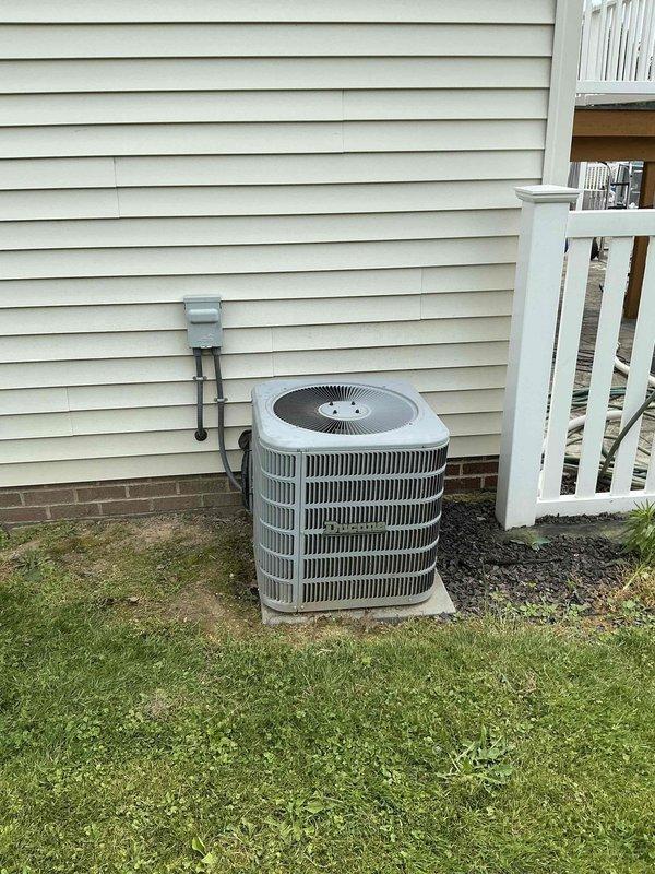 Completed HVAC system replacement estimate for a 12-year-old residential heating and cooling system. Assessed existing Thermolec furnace unit in basement mechanical room with associated ductwork, gas line, condensate drainage, and electrical connections, along with outdoor cylindrical air conditioning unit mounted on concrete pad. Documented current equipment condition, specifications, and installation configuration to provide comprehensive replacement quote for complete system upgrade.