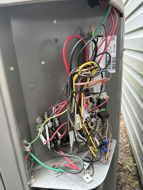 Completed MVP recurring cooling maintenance visit on 4-year-old residential split-system air conditioning unit. Performed comprehensive inspection of outdoor condenser unit, verifying proper operation of compressor and condenser fan motor. Inspected aluminum fin coil surfaces for debris accumulation and airflow restrictions. Opened electrical disconnect panel to examine all electrical connections, contactors, relays, and capacitor. Verified proper wire terminations and checked for signs of overheating or component degradation. Documented equipment condition through photographs showing condenser unit exterior, coil conditions, and internal electrical components. Unit operating within normal parameters with no immediate service needs identified. System ready for continued operation through cooling season.