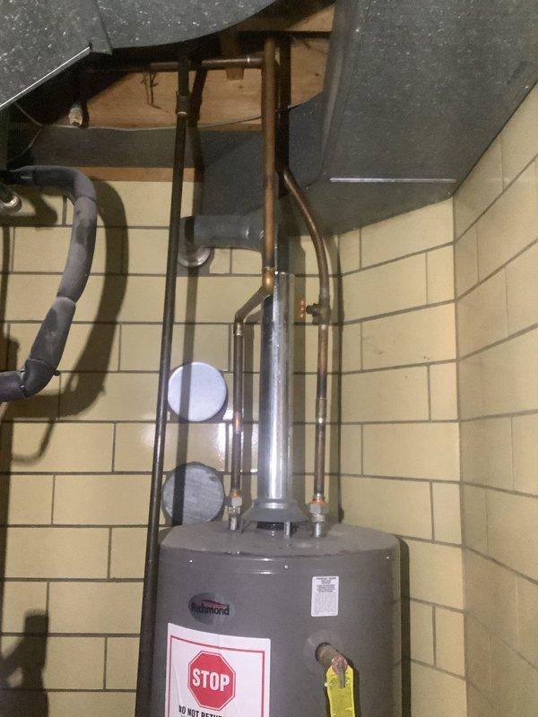 Responded to service call for leaking Richmond 40-gallon natural gas water heater, Model #6G40S-34F3, over 10 years old. Upon arrival, found significant standing water pooling around base of unit in utility room, confirming active leak from tank. Inspected water heater and determined tank failure due to age and internal corrosion, with leak originating from lower tank section. Recommended full unit replacement as tank leaks are not repairable. Documented existing installation configuration including copper supply lines, gas connections, and venting system for replacement specifications.