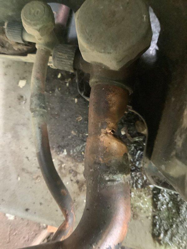 Responded to no cooling complaint on multiple 10-year-old air conditioning units. Upon inspection, discovered significant water accumulation inside HVAC cabinet and extensive corrosion on copper refrigerant lines and plumbing components. Standing water on unit floor indicated drainage system failure, with heavy staining on metal panels suggesting chronic moisture intrusion and possible secondary drain line blockage. Evaporator coil area showed debris accumulation and oxidation damage to copper piping connections. Documented severe corrosion throughout system components including rust on fittings and greenish patina on exposed copper. Water damage and deteriorated condition of refrigerant lines indicated system requires immediate attention to restore cooling functionality and prevent further damage to equipment.