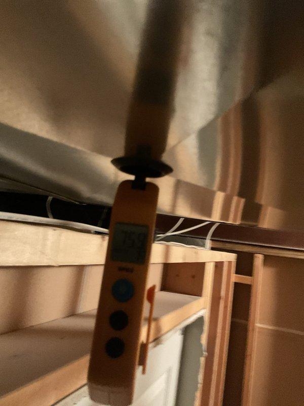 Responded to follow-up service call for non-operational air conditioning system. Previous technician had addressed a refrigerant line leak, but unit remained inoperative. Upon arrival, performed diagnostic assessment of the system including temperature readings at the indoor air handler location. Measurements indicated supply air temperature of 75°F at the ductwork, confirming lack of cooling output. Inspected accessible HVAC components in the attic space, including ductwork and air handler assembly. Based on the service history notation regarding PCB (printed circuit board) and continued system failure after line leak repair, conducted electrical system evaluation to identify control board malfunction as root cause of persistent no-cool condition.