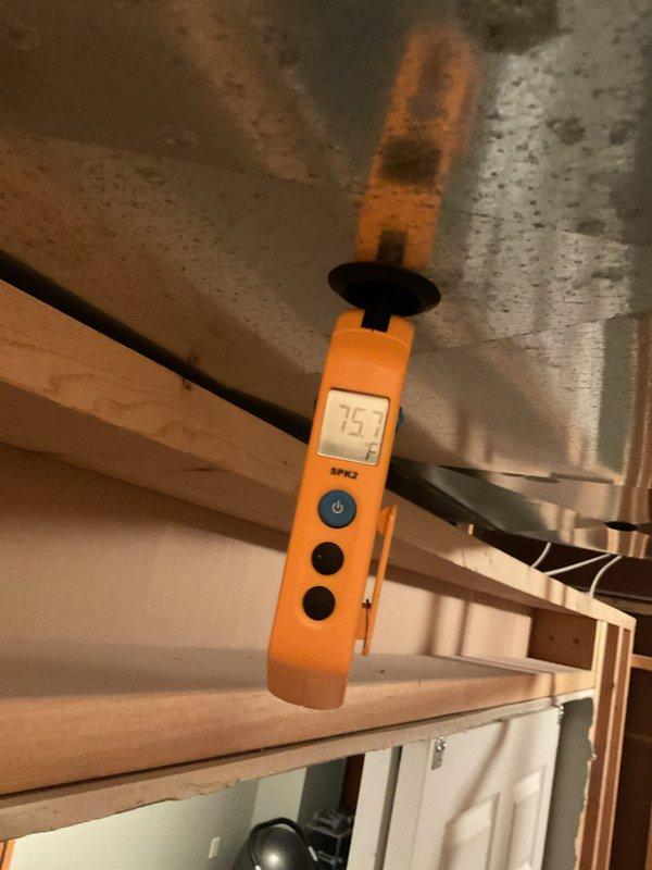 Responded to follow-up service call for non-operational air conditioning system. Previous technician had addressed a refrigerant line leak, but unit remained inoperative. Upon arrival, performed diagnostic assessment of the system including temperature readings at the indoor air handler location. Measurements indicated supply air temperature of 75°F at the ductwork, confirming lack of cooling output. Inspected accessible HVAC components in the attic space, including ductwork and air handler assembly. Based on the service history notation regarding PCB (printed circuit board) and continued system failure after line leak repair, conducted electrical system evaluation to identify control board malfunction as root cause of persistent no-cool condition.