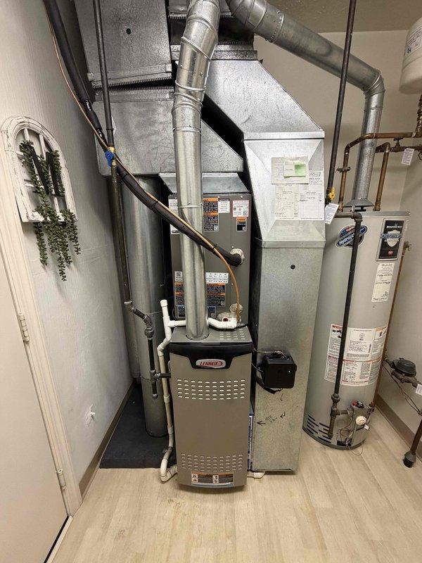 Completed installation of air conditioning evaporator coil and outdoor condensing unit as part of a split system HVAC upgrade. Installed new dual contactor with 25-amp fuses at the outdoor unit, ran electrical connections, and integrated the new A/C system with the existing Lennox furnace and ductwork infrastructure in the utility room. All equipment tested and operational upon completion.