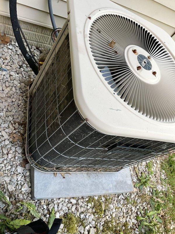 Responded to no cooling complaint on residential air conditioning system installed approximately 2 years ago. Upon arrival, performed visual inspection of outdoor condenser unit which showed signs of dust and debris accumulation on exterior mesh grilles. Documented system condition with photographs showing dual outdoor units positioned on concrete pad with gravel surround. Advised customer of diagnostic fee structure and coordinated communication regarding warranty coverage status before proceeding with further troubleshooting.