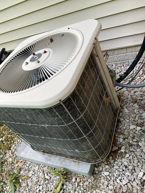Responded to no cooling complaint on residential air conditioning system installed approximately 2 years ago. Upon arrival, performed visual inspection of outdoor condenser unit which showed signs of dust and debris accumulation on exterior mesh grilles. Documented system condition with photographs showing dual outdoor units positioned on concrete pad with gravel surround. Advised customer of diagnostic fee structure and coordinated communication regarding warranty coverage status before proceeding with further troubleshooting.