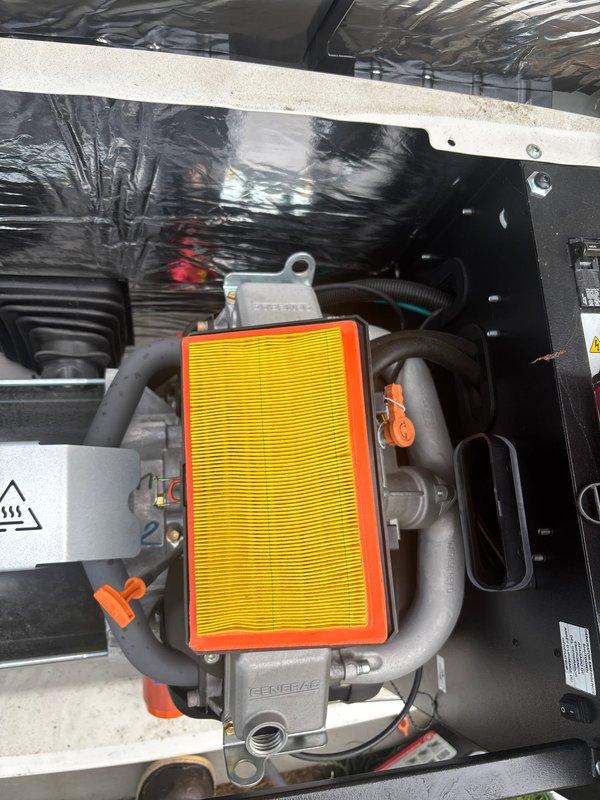 Performed routine preventive maintenance on residential 22kW Generac standby generator. Inspected engine compartment, verified air filter condition, checked all hose connections and mounting hardware for proper security, and confirmed unit operational status with indicator lights functioning correctly. Discussed ongoing maintenance plan options with property owner to ensure continued reliable backup power system performance.