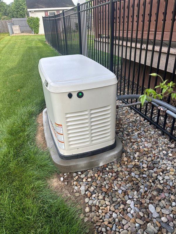 Performed routine preventive maintenance on residential 22kW Generac standby generator. Inspected engine compartment, verified air filter condition, checked all hose connections and mounting hardware for proper security, and confirmed unit operational status with indicator lights functioning correctly. Discussed ongoing maintenance plan options with property owner to ensure continued reliable backup power system performance.