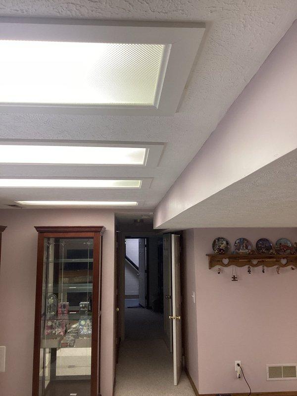 Installed and wired new recessed fluorescent lighting fixtures in residential interior spaces. Ran electrical circuit wiring to provide power distribution for the newly installed ceiling-mounted light fixtures, ensuring proper illumination in multiple rooms with textured ceilings and angled architectural features.