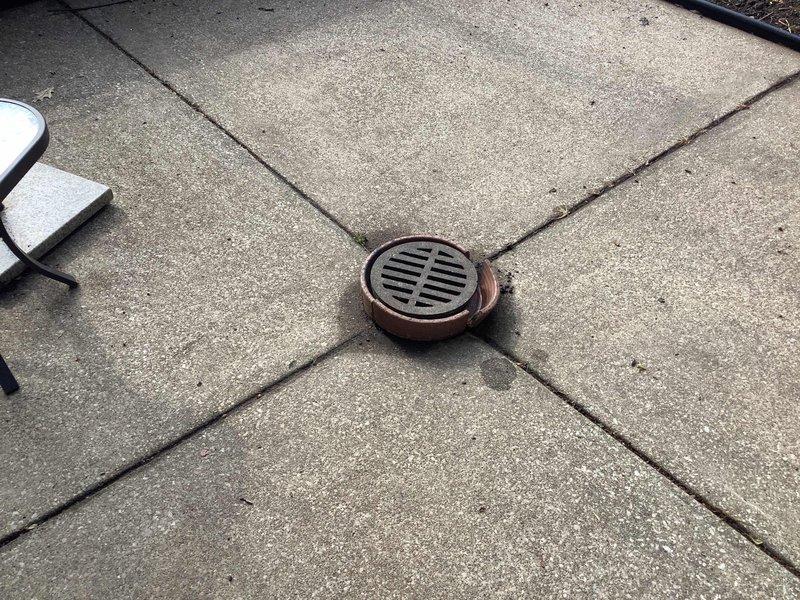 Responded to water leak complaint following previous repair work on exterior spigot. Upon inspection, discovered that activating the outdoor faucet caused water intrusion through interior ceiling, indicating a compromised supply line or connection point between the exterior hose bib and interior plumbing system. Documented exterior spigot location on concrete patio area near drainage system and foundation perimeter where leak originated. Further investigation required to access concealed piping within wall cavity to identify exact failure point and complete permanent repair of water supply line.