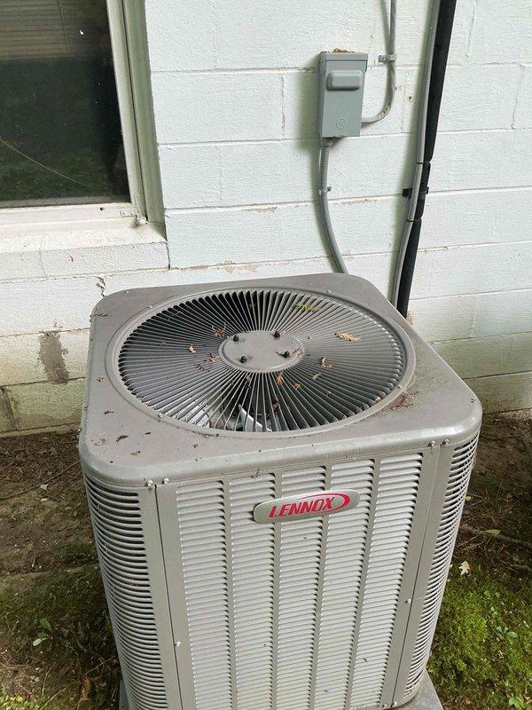 Completed scheduled MVP cooling maintenance visit on 6-year-old Lennox condensing unit and associated air handler system. Performed comprehensive system inspection including examination of evaporator coil assembly, refrigerant line connections, and condensate drain pan at indoor unit. Observed copper refrigerant tubes showing normal patina oxidation consistent with system age. Inspected outdoor condensing unit positioned on concrete pad, noting accumulation of debris on fan grille which was cleared to ensure proper airflow. Verified electrical disconnect box and conduit connections at exterior installation. System operational and functioning within normal parameters upon completion of maintenance protocol.