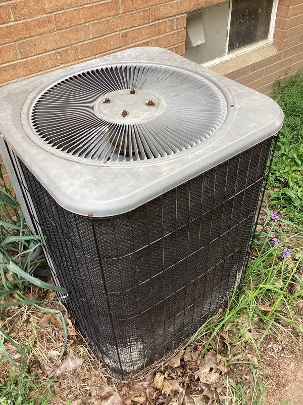 Responded to service call for non-operational condenser fan motor. Upon inspection, found outdoor AC unit with significant debris accumulation and weathered components. Diagnosed fan motor failure, replaced defective motor assembly, cleaned condenser coil and surrounding area of leaves and debris, verified proper airflow through unit, and tested system operation to confirm cooling cycle functioning correctly.