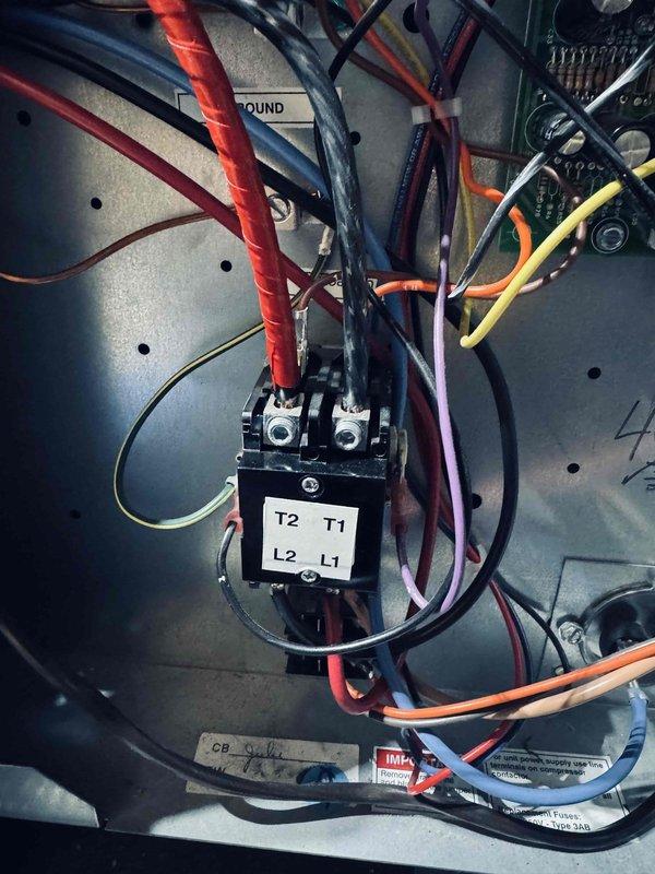 Completed scheduled maintenance on 9-year-old geothermal cooling system. Inspected electrical connections at control panel, verified proper wire terminations at contactor terminals T1/T2 and L1/L2, and examined air handler blower motor assembly rated at 14.4/19.2 AMP, 208/240V, 1500 CFM. All components operating within manufacturer specifications with no deficiencies noted.