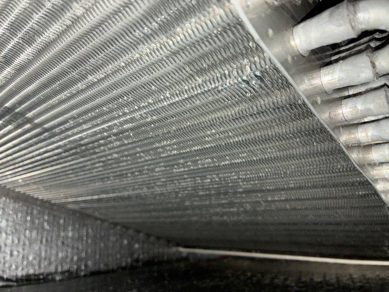 Completed scheduled MVP cooling maintenance visit on HVAC system. Performed comprehensive inspection of evaporator coil assembly and associated ductwork, documenting current condition of heat exchanger fins and insulated ducting components. Coil fins showed typical dust accumulation from normal operation; all mechanical components and duct connections found secure and functioning within normal parameters.