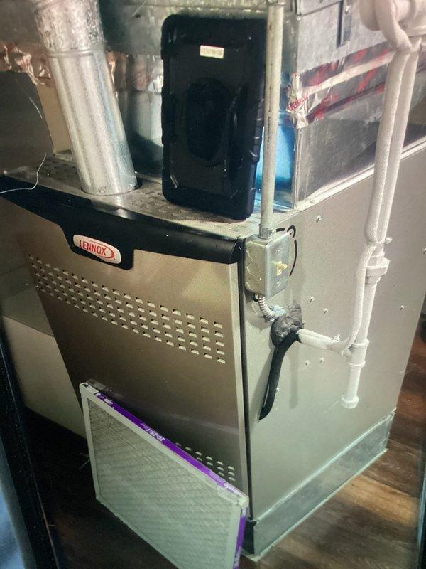 Responded to water leak service call for residential Lennox furnace system. Upon inspection, identified blocked condensate drain line as source of issue. Cleared obstruction from condensate line using appropriate tools and techniques to restore proper drainage flow. Verified condensate trap and PVC drainage piping configuration for proper operation. Tested system operation to confirm condensate was draining freely through trap and drain line without backup or overflow. System returned to normal operation with no further leakage detected.