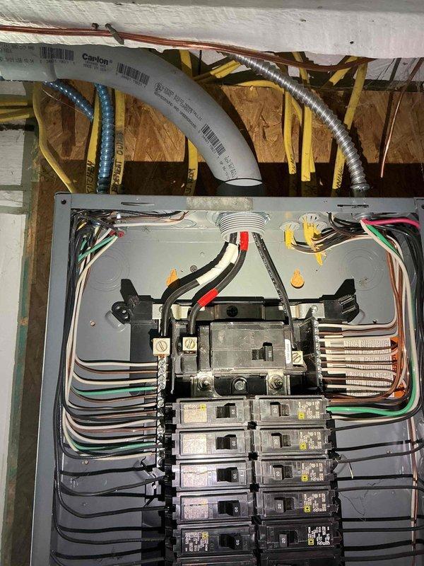 Conducted comprehensive electrical assessment for backup generator installation at residential property. Evaluated existing electrical panel configuration, circuit capacity, and available breaker positions to determine optimal integration point for automatic transfer switch. Documented current electrical service infrastructure including main panel wiring, grounding system, and utility room conditions. Photographed panel interior showing circuit breaker arrangement, wire routing, and available knockout locations for future generator connection. Assessed basement utility area for generator transfer switch placement, noting existing plumbing lines, structural framing, and wall conditions that may impact installation routing.