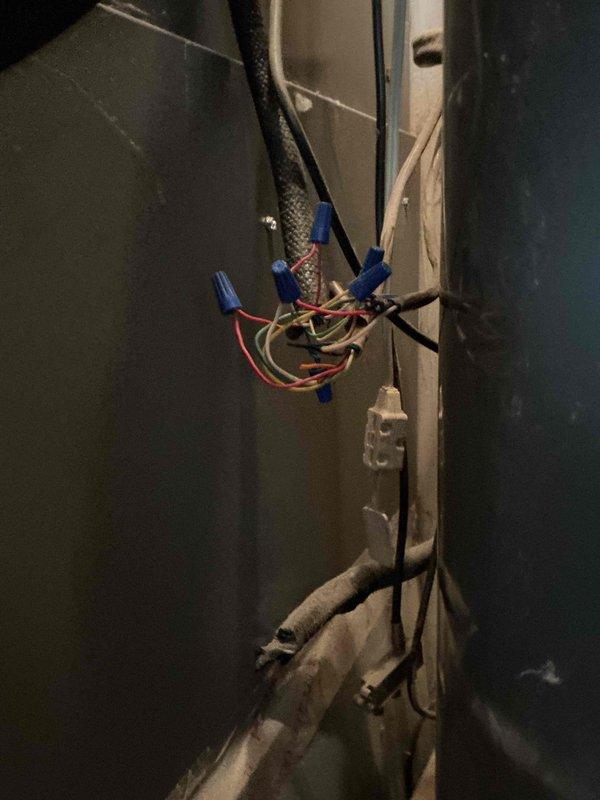 Responded to service call for malfunctioning thermostat. Upon arrival, inspected Aprilaire digital thermostat and associated low-voltage wiring connections at air handler. Found loose wire connections at junction point causing intermittent communication between thermostat and HVAC system. Secured all low-voltage wiring connections using proper wire nuts, verified proper voltage at thermostat terminals, and confirmed thermostat display and system response functioning correctly. System tested and operational.