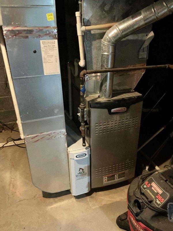 Conducted comprehensive assessment of existing HVAC system for equipment replacement estimate. Evaluated current installation consisting of aging air handler, Lennox furnace, and associated ductwork in basement mechanical room. Documented system configuration including refrigerant lines, condensate drainage, electrical connections, and duct transitions. Noted significant frost accumulation on evaporator coil indicating active cooling operation. Photographed equipment layout, clearances, and existing infrastructure to develop accurate replacement specifications and scope of work for customer consideration.