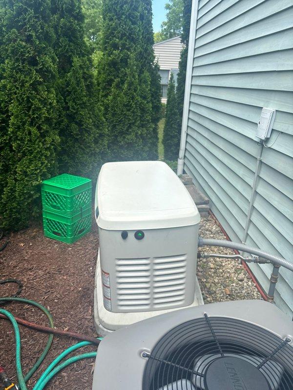 Completed scheduled maintenance on residential standby generator unit. Performed comprehensive system inspection including visual examination of exterior housing, ventilation louvers, and mounting pad integrity. Conducted battery load test using diagnostic equipment, confirming battery health at 100% state of health with proper charging voltage of 14.86V and adequate cold cranking amps. Verified all electrical connections, conduit routing, and exhaust system components were secure and functioning properly. Generator operational status confirmed with indicator lights showing normal operation.