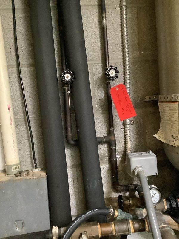 Provided estimate for replacement of well pump pressure tank, installation of new pressure gauge on tank, and installation of new exterior hose spigot. Inspected existing system including current pressure tank, piping configuration, zone valves, and associated plumbing components in mechanical room. Documented existing conditions with photographs showing current pressure tank setup, brass fittings, control devices, and insulated refrigerant lines. Recommended complete pressure tank replacement due to age and performance concerns, along with upgraded pressure monitoring capabilities and addition of outdoor water access point.