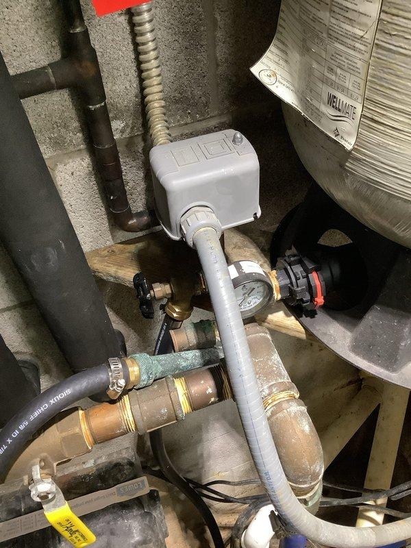 Provided estimate for replacement of well pump pressure tank, installation of new pressure gauge on tank, and installation of new exterior hose spigot. Inspected existing system including current pressure tank, piping configuration, zone valves, and associated plumbing components in mechanical room. Documented existing conditions with photographs showing current pressure tank setup, brass fittings, control devices, and insulated refrigerant lines. Recommended complete pressure tank replacement due to age and performance concerns, along with upgraded pressure monitoring capabilities and addition of outdoor water access point.