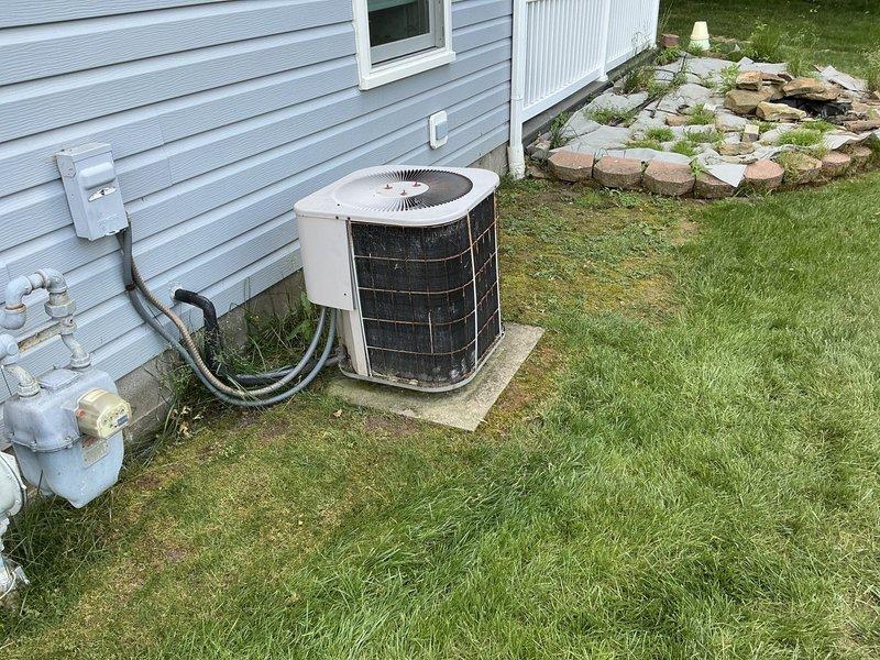 Completed estimate for no cooling complaint on residential split system HVAC unit. Assessed outdoor condenser unit with beige housing and indoor air handler in basement utility room. Documented existing equipment condition and installation site for replacement system proposal.