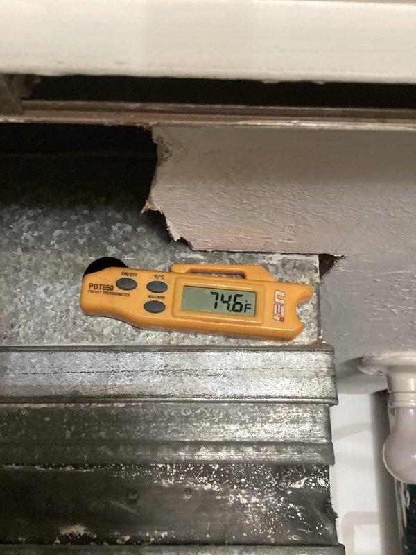 Responded to service call for 8-year-old air conditioning system not adequately cooling residence. Performed system diagnostics including visual inspection of evaporator coil and temperature measurements. Evaporator coil fins found in clean condition with proper airflow. Recorded ambient temperature reading of 74.6°F at air handler location to establish baseline operating conditions for further system evaluation.
