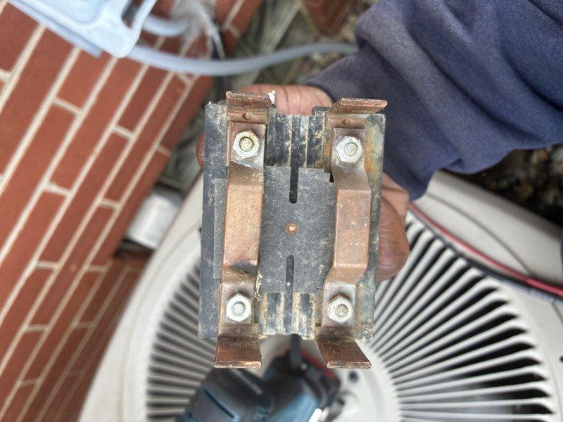 Completed MVP cooling maintenance visit on 12-year-old system. Performed electrical diagnostics using clamp meter, recording amperage readings of 251-254 amps on refrigerant lines. Inspected and documented heavily corroded contactor showing significant oxidation, carbon buildup, and deterioration on copper terminals and mounting hardware, indicating component is nearing end of service life and will require replacement in near future to prevent system failure.