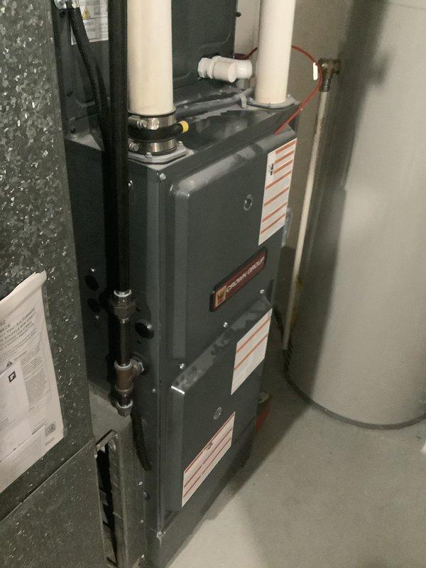 Conducted on-site evaluation for residential HVAC system experiencing no cooling condition. Assessed existing Crown Group outdoor condensing unit and indoor furnace system located in basement utility area. Documented current equipment configuration including PVC condensate drainage, refrigerant line sets, and electrical connections. Provided comprehensive replacement estimate for complete system upgrade to address cooling failure and equipment age concerns.