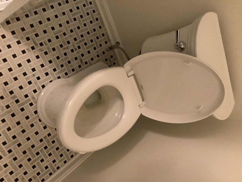 Rebuilt flapper assembly and replaced tank lever on American Standard Heritage toilet in first floor powder room. Special order handle was procured and installed to restore proper flush operation. Work completed upon parts arrival at shop.
