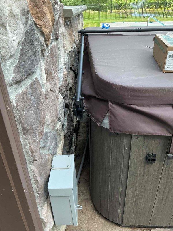 Installed electrical disconnect box and conduit for hot tub replacement on exterior stone wall, ensuring proper GFCI protection and code-compliant wiring. Additionally installed seven pendant light fixtures in kitchen area to complete electrical service request.