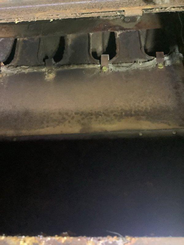 Responded to no-cooling call on approximately 20-year-old air conditioning system. Upon arrival, confirmed outdoor condenser unit was not operating. Performed diagnostic evaluation of both indoor air handler and outdoor condensing unit. Inspected evaporator coil assembly showing significant age-related deterioration, dust accumulation, and corrosion on metal components. Examined outdoor condenser unit which exhibited substantial weathering, debris accumulation around base, and visible grime on protective grille and coil surfaces. Verified electrical supply at breaker panel and traced power to equipment. System required comprehensive assessment due to advanced age and lack of recent maintenance, with multiple components showing end-of-service-life conditions.