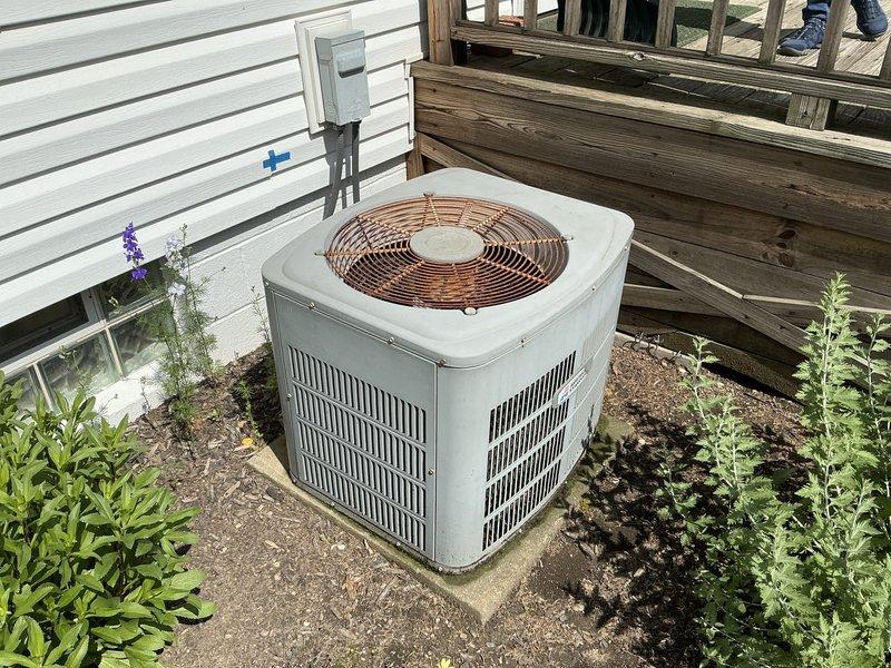 Conducted on-site evaluation for complete HVAC system replacement at residential property. Assessed existing outdoor condensing unit located on concrete pad in side yard with adequate clearance and electrical disconnect, as well as secondary unit positioned between house and fence line with utility connections. Documented current equipment specifications, installation conditions, and site access requirements to prepare comprehensive replacement estimates for both air conditioning system and furnace upgrade.