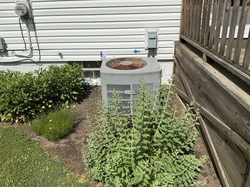 Conducted on-site evaluation for complete HVAC system replacement at residential property. Assessed existing outdoor condensing unit located on concrete pad in side yard with adequate clearance and electrical disconnect, as well as secondary unit positioned between house and fence line with utility connections. Documented current equipment specifications, installation conditions, and site access requirements to prepare comprehensive replacement estimates for both air conditioning system and furnace upgrade.