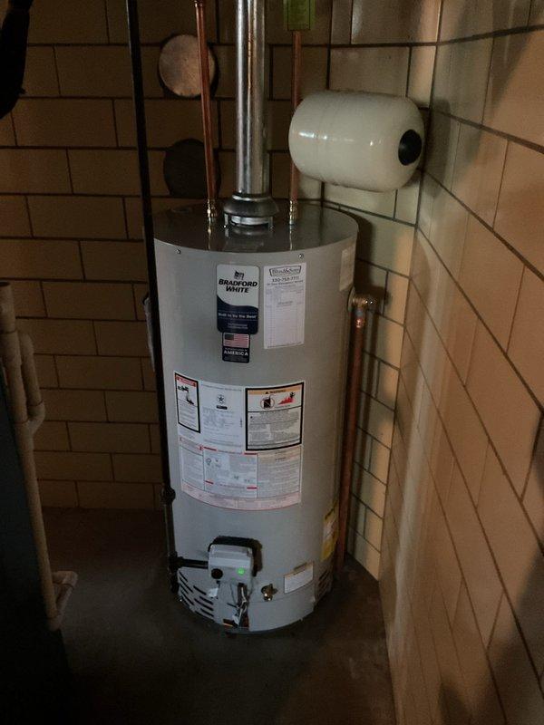 Removed existing Richmond water heater and installed new Bradford White unit with full code compliance upgrades. Installation included new ball valve shut-off, gas shut-off valve, thermal expansion tank, and proper electrical bonding of the system. Verified all connections for leaks, hauled away old unit, and completed manufacturer warranty registration for the 6-year coverage period.