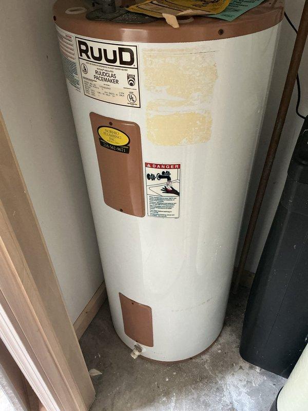 Responded to no hot water complaint on 26-year-old residential water heater. Upon arrival, performed diagnostic inspection of tanked water heater unit. Identified Bradford White 48-gallon automatic storage water heater (Serial #0WA1519761) that had reached end of service life and was no longer producing hot water. Documented existing equipment condition with photographs showing unit specifications, safety labels, and overall installation. Unit exhibited typical age-related failure consistent with expected lifespan for residential water heating equipment. Advised customer of findings and provided recommendations for replacement options.
